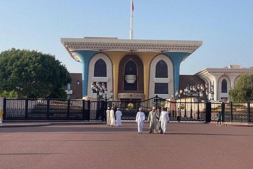 A large, historic building with arched windows and a flagpole. 4
