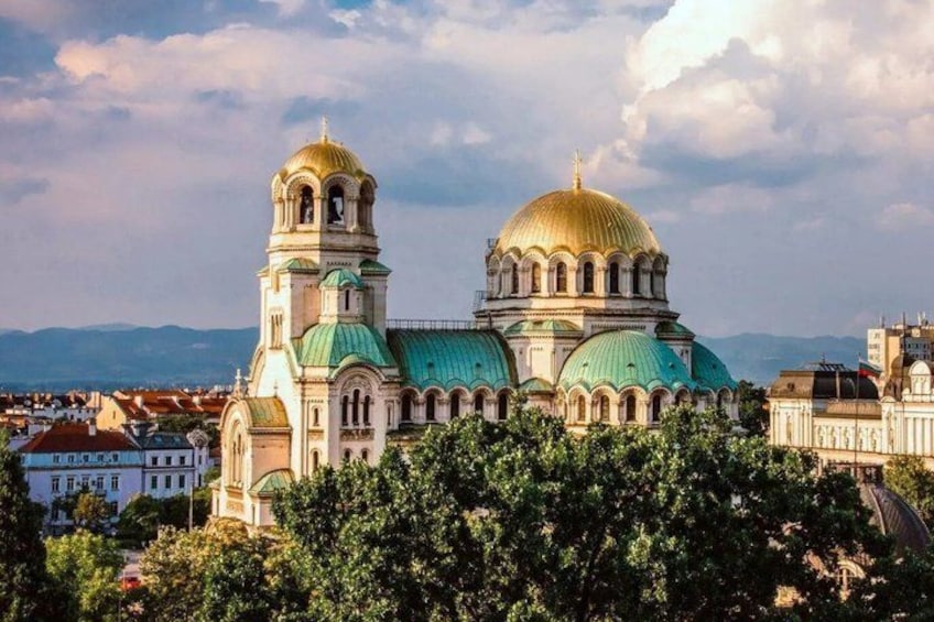 A large church with two domes and a bell tower. 1