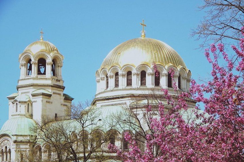 A large church with two domes and a bell tower. 4