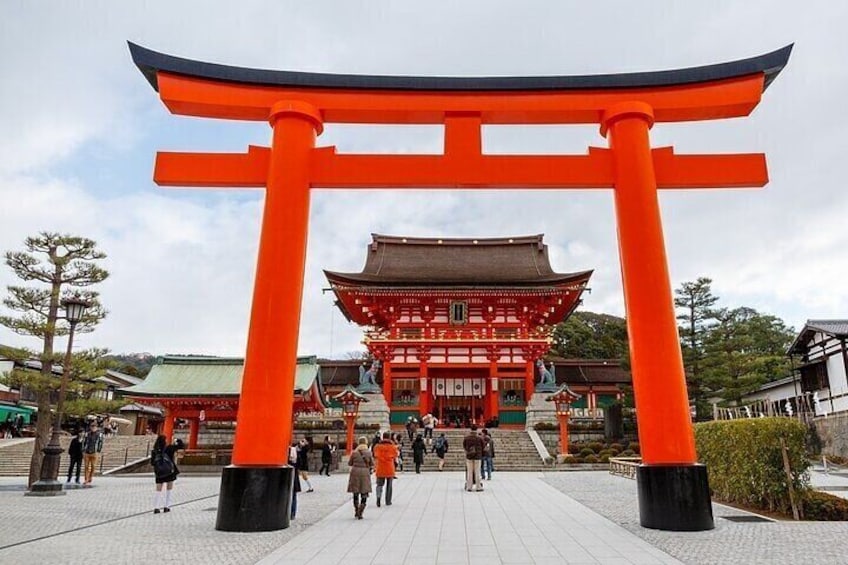 A traditional Japanese building with a red torii gate in front. 1