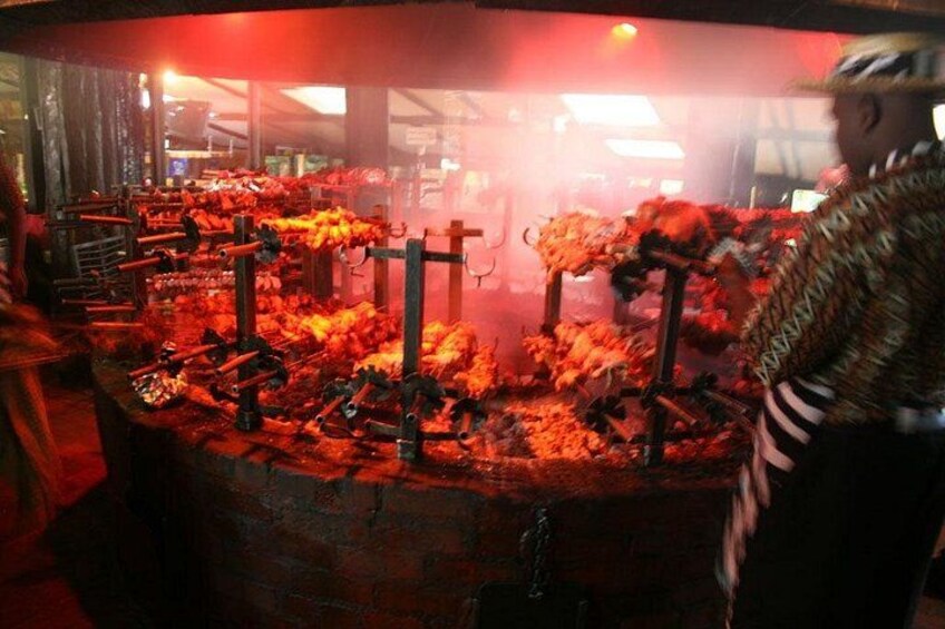 A large outdoor cooking area with multiple grills and cooking equipment. 3
