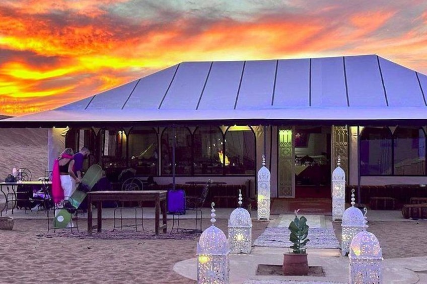 A covered outdoor area with a metal roof, benches, and decorative lanterns. 5