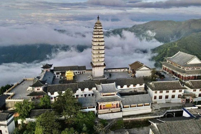A traditional pagoda, a temple complex, and surrounding mountainous landscape. 2