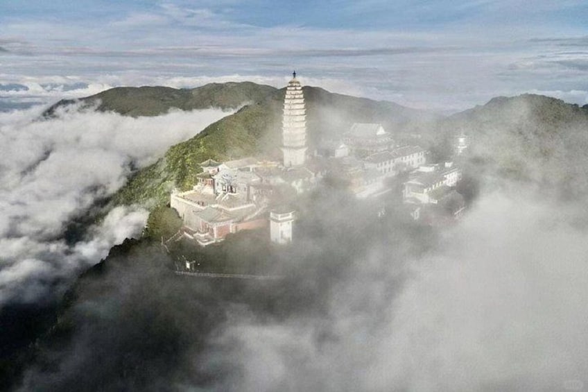 A pagoda surrounded by misty mountains. 3