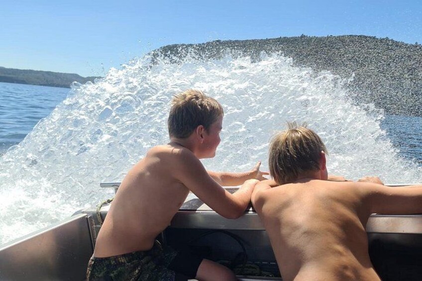 Boys playing with the boat spray on the return journey 3