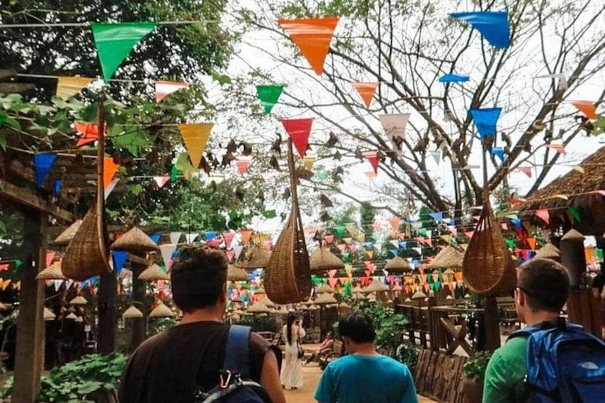 A market with hanging baskets and colorful flags. 2
