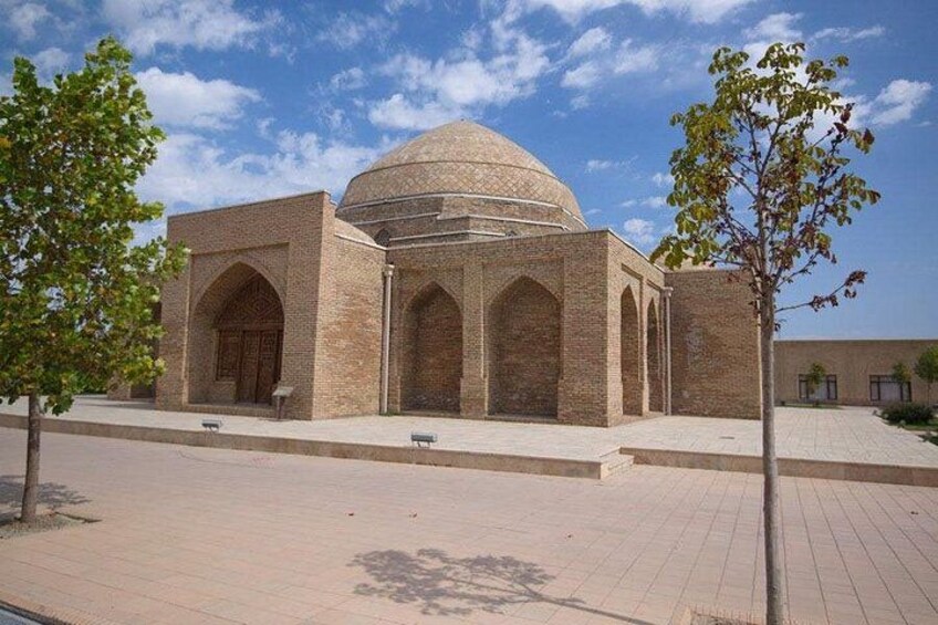 A mosque with a large dome and arched entrance. 4