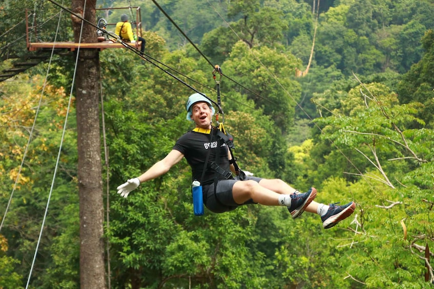 A person zip-lining through a forest. 2
