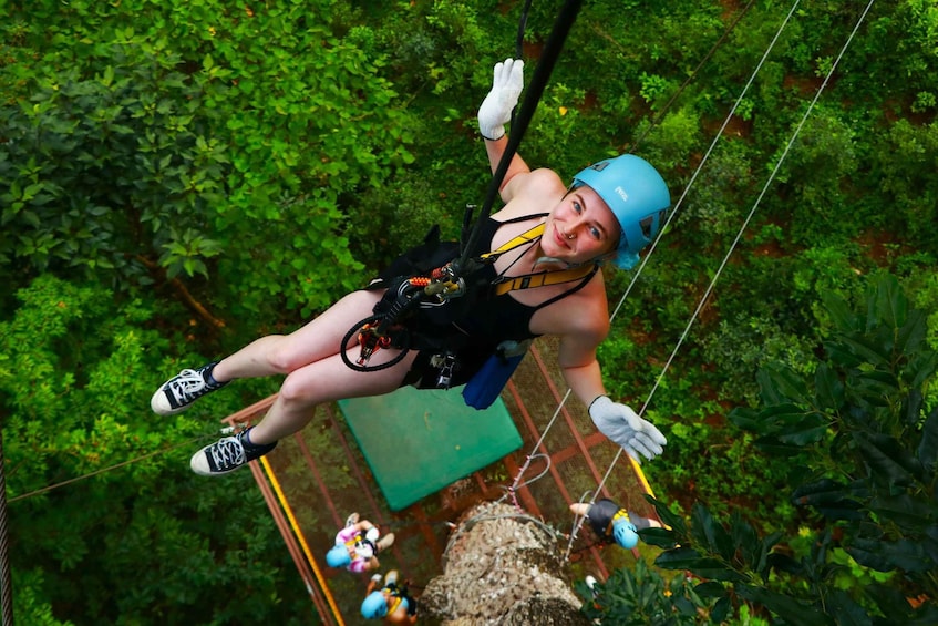 A person bungee jumping from a bridge with safety harness and helmet. 3