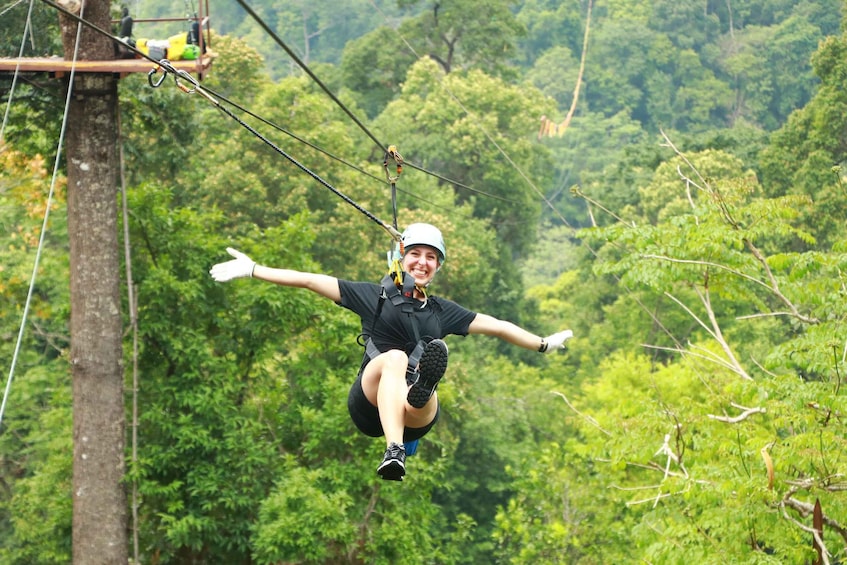 A person zip-lining through a forest. 4