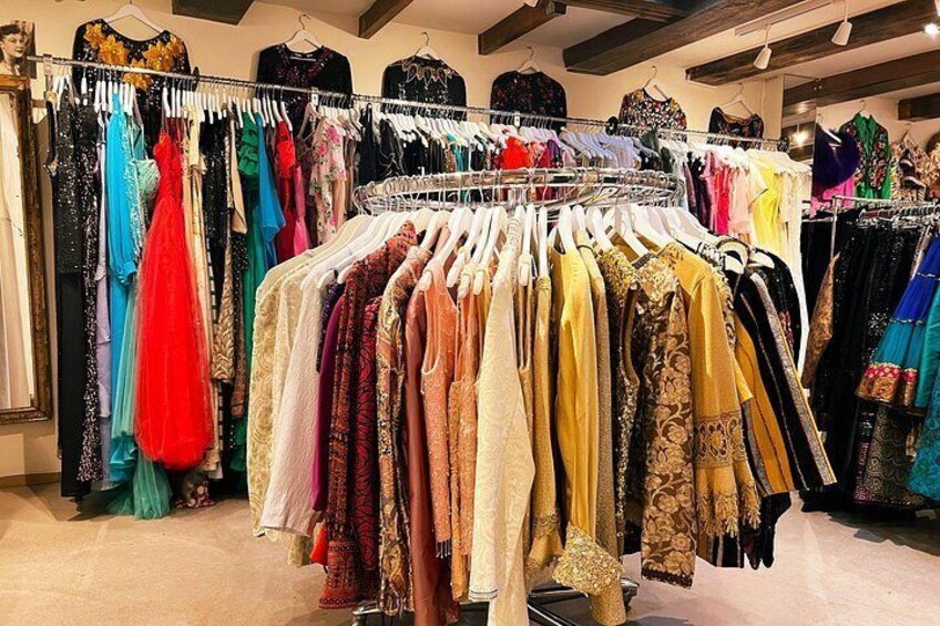 A clothing store with racks of dresses in various colors and patterns. 5