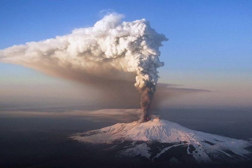 A volcanic eruption with a large plume of ash and smoke. 4