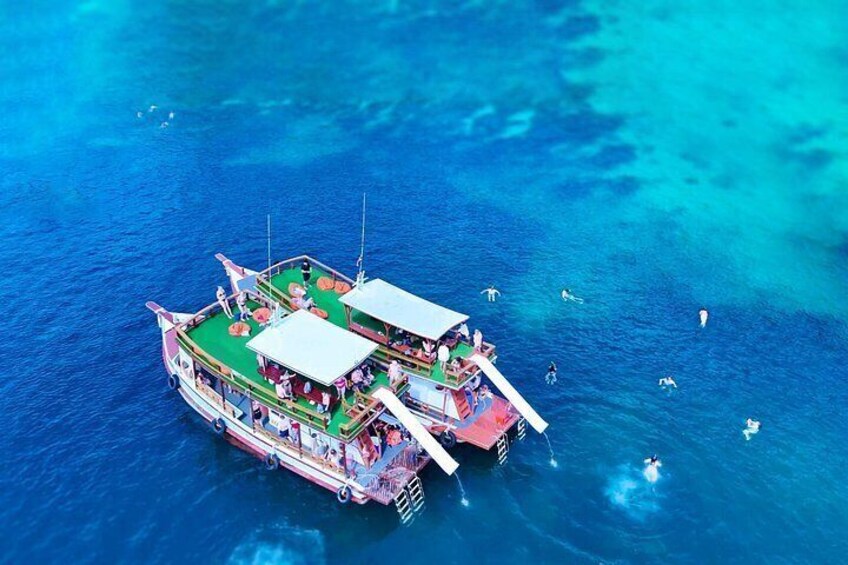 A floating structure with multiple levels, surrounded by clear blue water. 4
