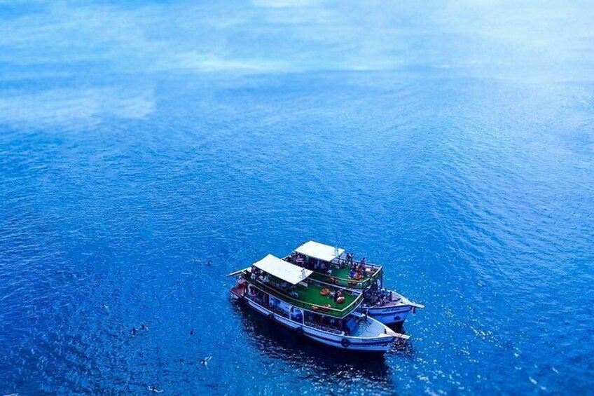 A large boat with multiple decks floating on a calm blue sea. 2
