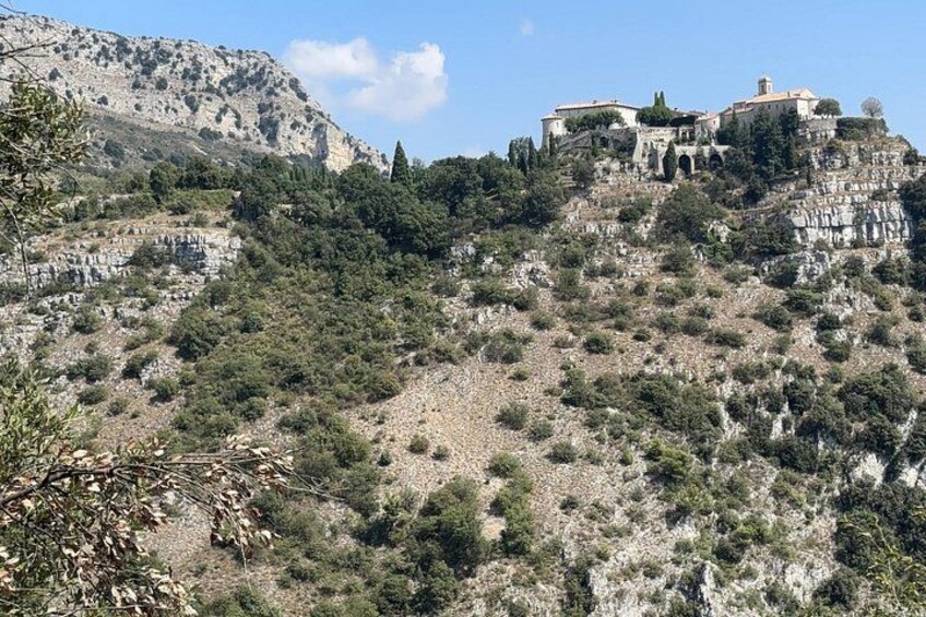 A mountainous landscape with a historic building complex on a hill. 4