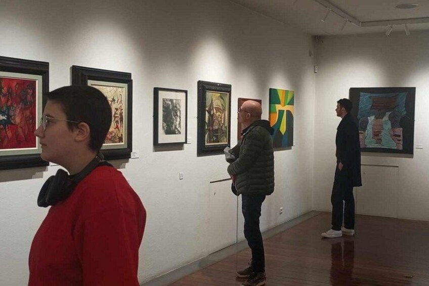 An art gallery with paintings on the walls. 5