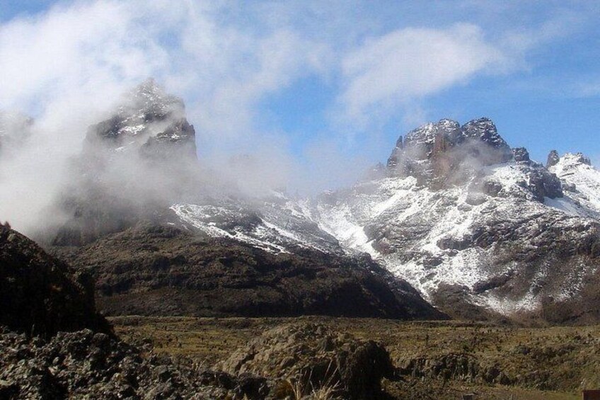 A mountainous landscape with snow-covered peaks and a valley. 2