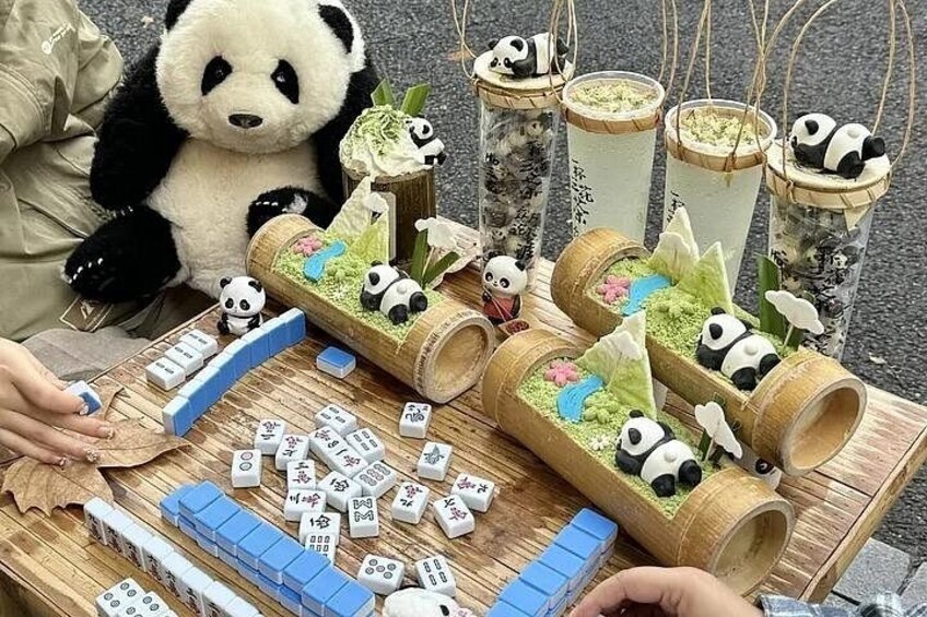 A person playing a game of Mahjong with panda-themed decorations. 5