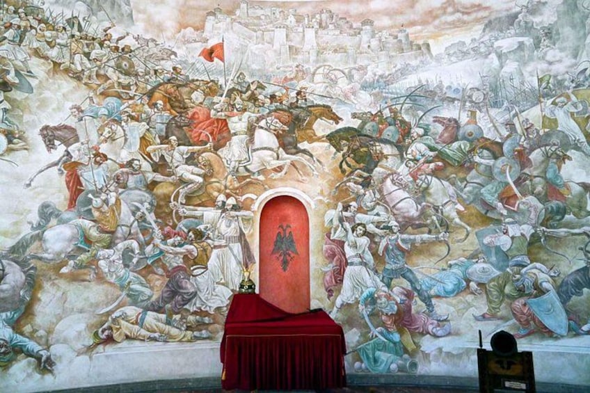 A mural with a central red archway, depicting a historical battle scene with soldiers, horses, and a city in the background. 3