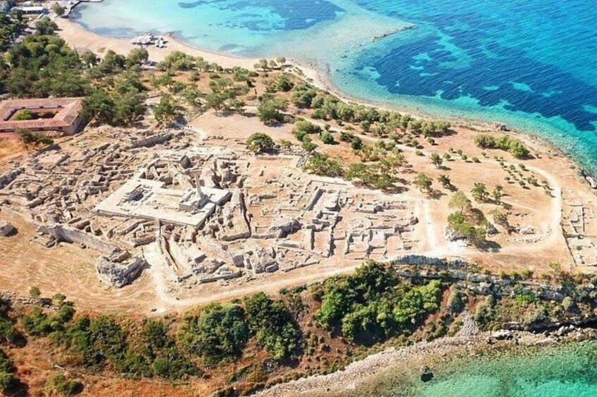 An ancient archaeological site with ruins and a beach. 1