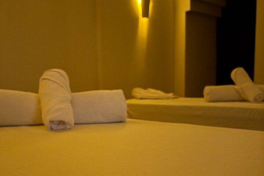 A hotel room with neatly folded towels on the beds. 4