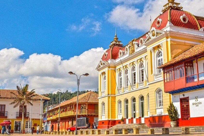 A colorful building with a red dome and yellow walls. 5