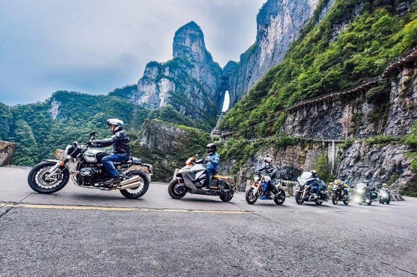 Motorcycles on a road with a mountainous landscape in the background. 1