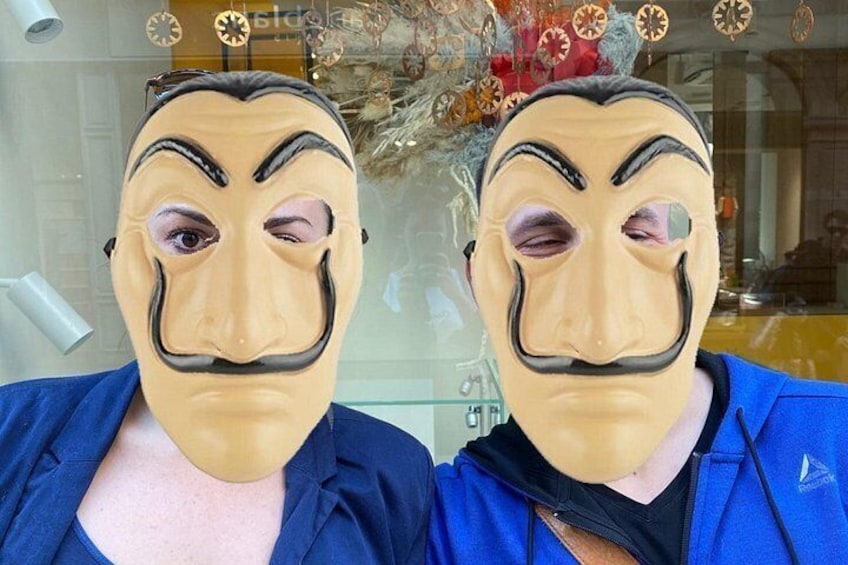 A person wearing a blue jacket with a mask. 4