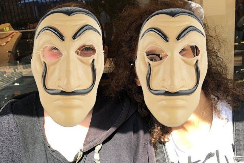 Two people wearing masks with curly hair. 3