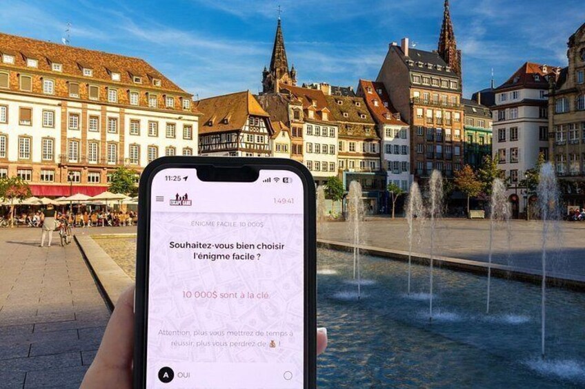 A smartphone displaying a message in French with a historic European town square in the background. 5