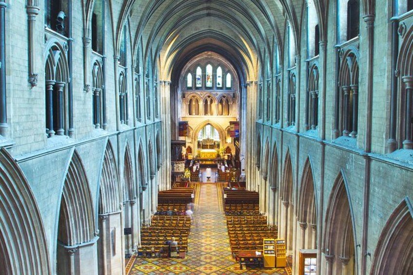 A cathedral interior with arched ceilings, stained glass windows, and a central aisle leading to an altar. 4