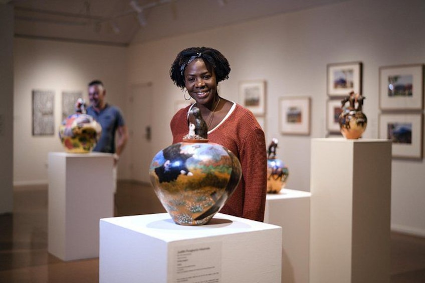 An art gallery with sculptures on pedestals. 5