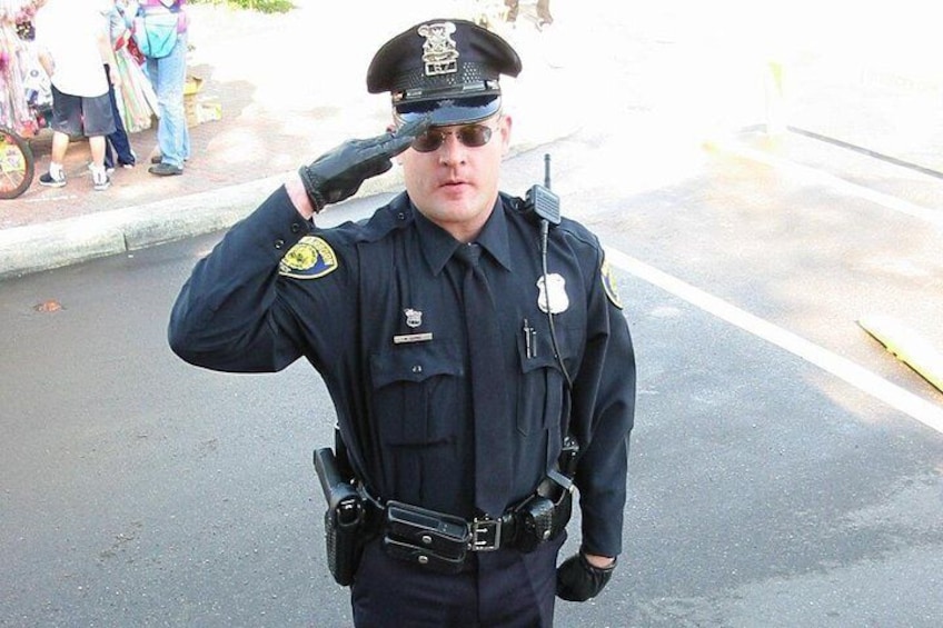 A uniformed individual saluting. 1