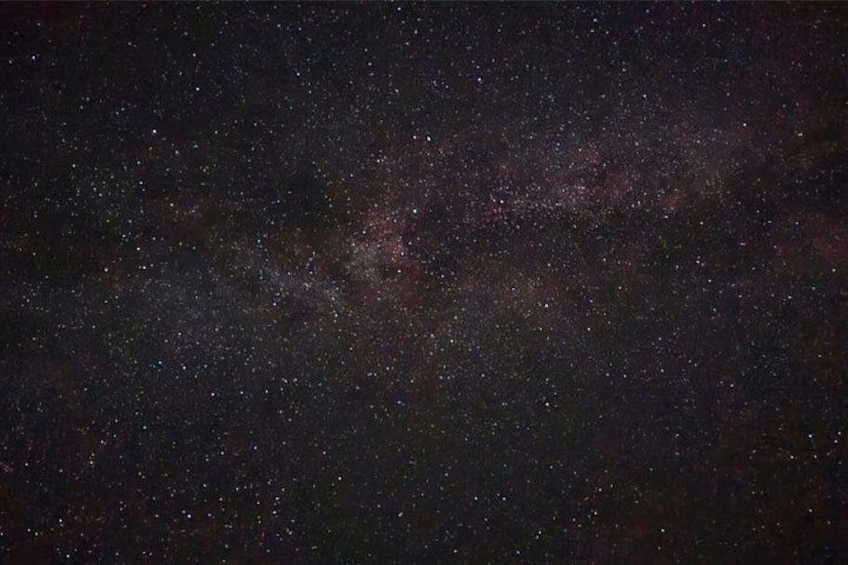 A starry night sky with visible stars and a faintly visible galaxy. 4