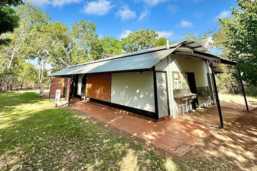 A modern house with a sloped roof, wooden deck, and a covered outdoor area. 5