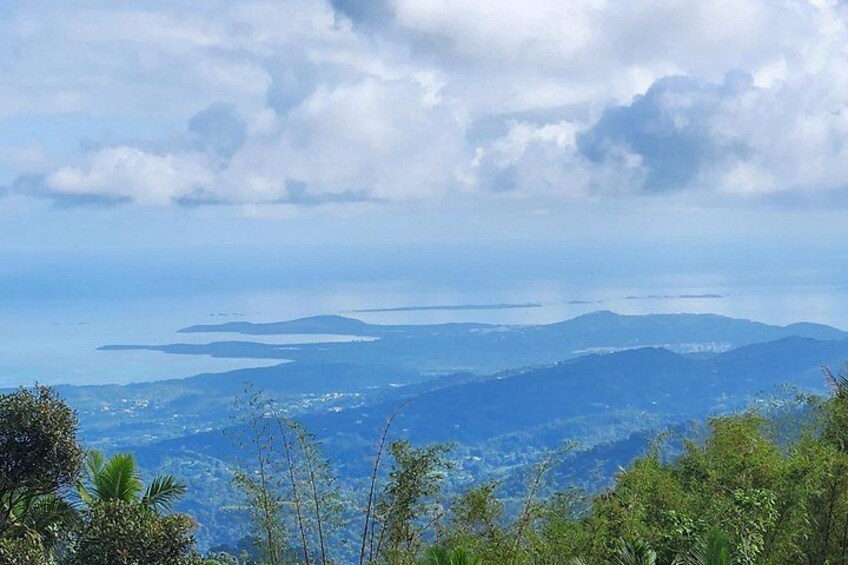 A mountainous landscape with a view of the sea and distant islands. 4