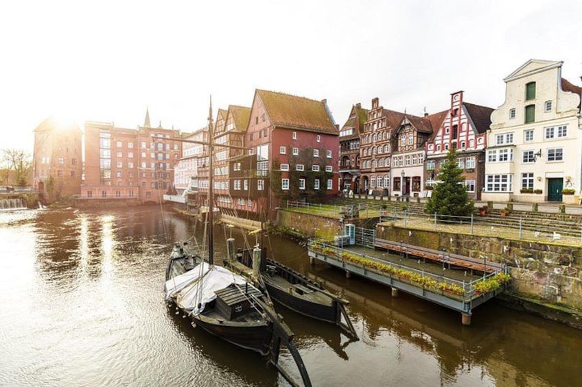A canal with boats, historic buildings, and a bridge. 2
