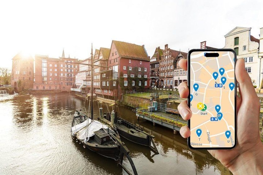 A smartphone displaying a map with location pins, a canal, and traditional buildings. 1