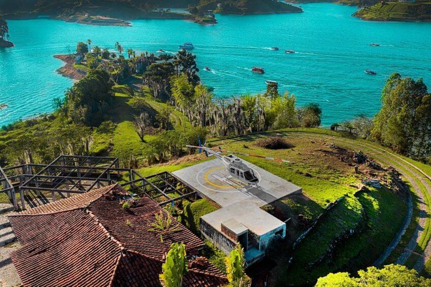 A coastal landscape with a paved area, a road, and a body of water with boats. 5