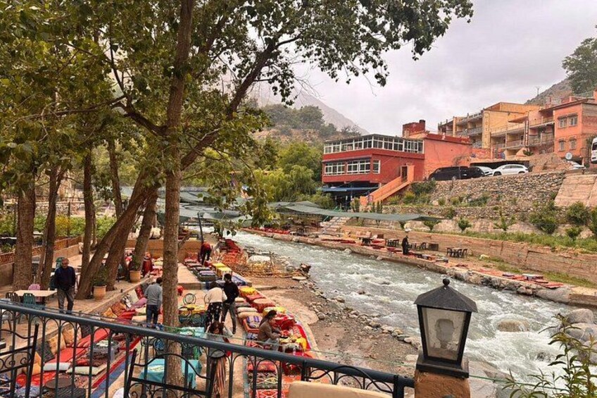 A river with boats, people, and buildings in the background. 2