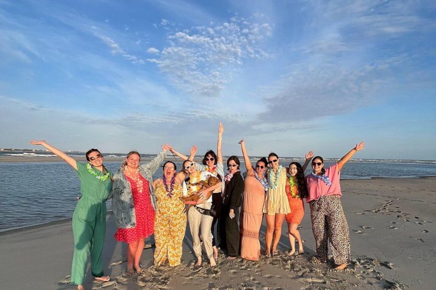 A group of people on a beach with the ocean in the background. 5