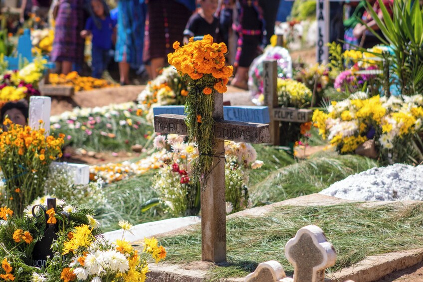 A cemetery with colorful flowers and headstones. 3