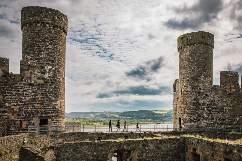 A historic castle with two large towers and a moat. 2