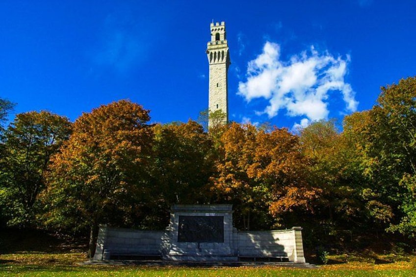 A tower with a clock, surrounded by autumn trees. 4