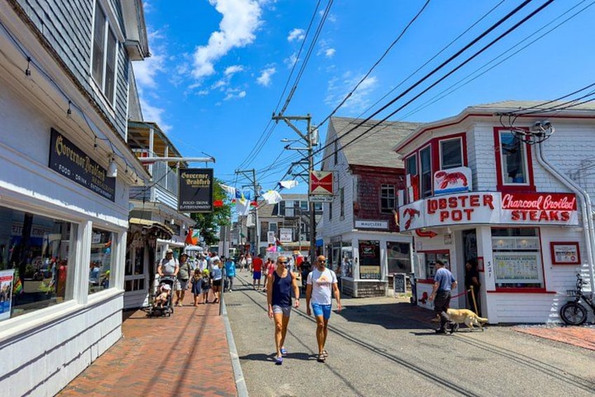 A street with shops, a lobster pot restaurant, and a tram. 3