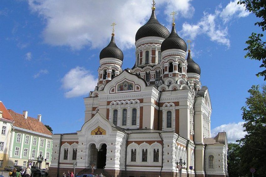 A large, ornate church with multiple domes and a prominent cross on top. 4