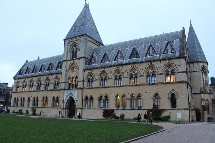 A large, historic building with a prominent tower and arched windows. 3