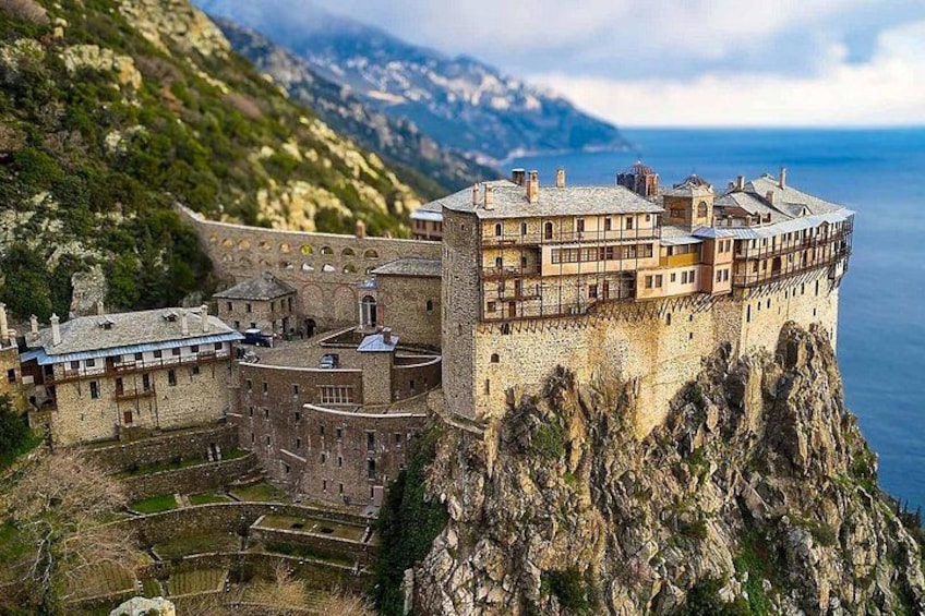 A castle perched on a cliff overlooking a body of water. 1