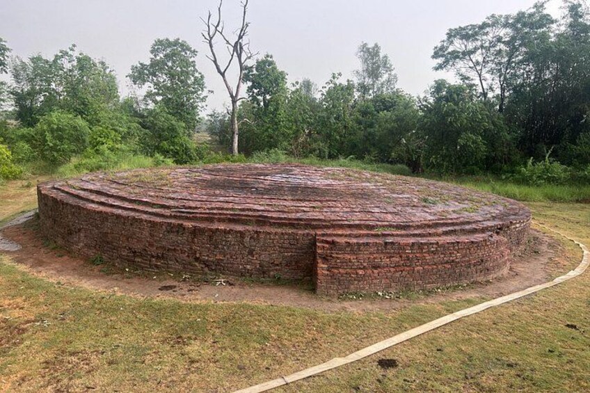 Une structure circulaire en briques, avec un chemin qui y mène. 5