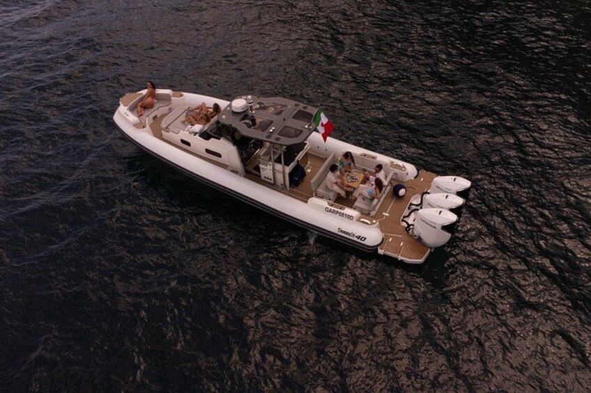 A large, luxurious yacht with multiple decks and seating areas, floating on a dark body of water. 4